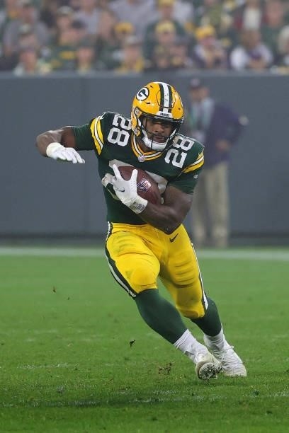 Dillon of the Green Bay Packers runs for yards during a game against the Pittsburgh Steelers at Lambeau Field on October 03, 2021 in Green Bay,...