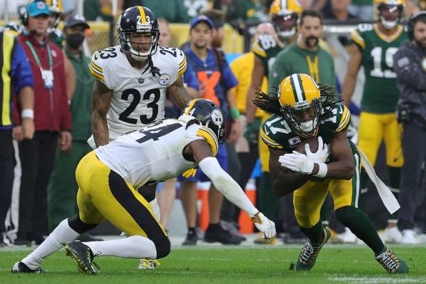 Davante Adams of the Green Bay Packers is pursued by Terrell Edmunds of the Pittsburgh Steelers during a game at Lambeau Field on October 03, 2021 in...