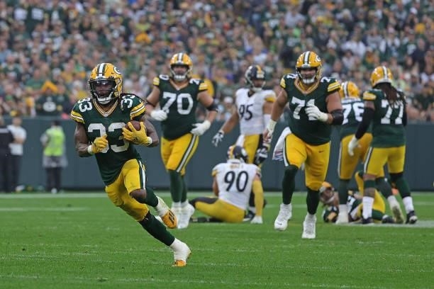 Aaron Jones of the Green Bay Packers runs for yards during a game against the Pittsburgh Steelers at Lambeau Field on October 03, 2021 in Green Bay,...