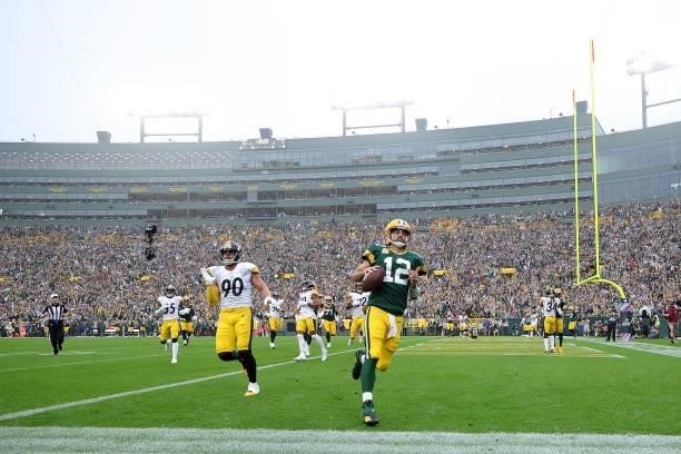 Aaron Rodgers of the Green Bay Packers rushes for a touchdown during a game against the Pittsburgh Steelers at Lambeau Field on October 03, 2021 in...