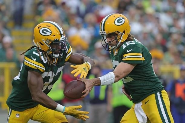 Aaron Rodgers hands the ball to Aaron Jones of the Green Bay Packers during a game against the Pittsburgh Steelers at Lambeau Field on October 03,...