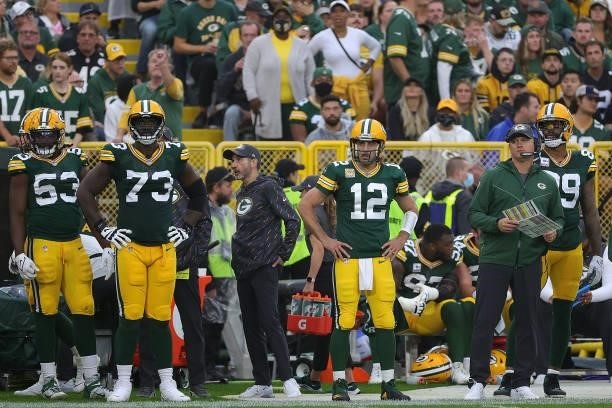 Jonathan Garvin, Yosh Nijman and Aaron Rodgers of the Green Bay Packers watches action during a game against the Pittsburgh Steelers at Lambeau Field...