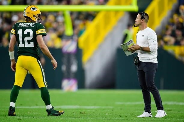 Aaron Rodgers and head coach Matt LaFleur of the Green Bay Packers talk on the field in the second half against the Pittsburgh Steelers at Lambeau...