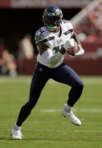 Metcalf of the Seattle Seahawks runs with the ball after catching a pass against the San Francisco 49ers during the third quarter of an NFL football...