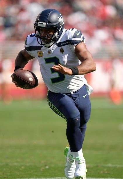 Russell Wilson of the Seattle Seahawks runs for a touchdown against the San Francisco 49ers during the third quarter at Levi's Stadium on October 03,...