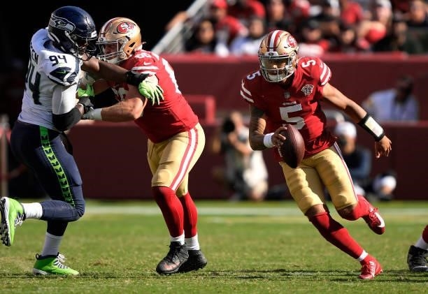 Trey Lance of the San Francisco 49ers scrambles with the ball during the fourth quarter against the Seattle Seahawks at Levi's Stadium on October 03,...