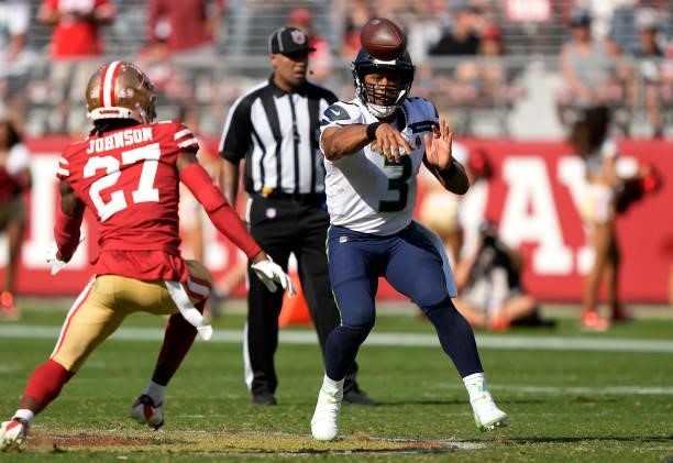 Russell Wilson of the Seattle Seahawks throw a pass against the San Francisco 49ers during the fourth quarter at Levi's Stadium on October 03, 2021...