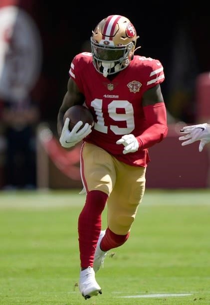 Deebo Samuel of the San Francisco 49ers runs with the ball after catching a pass against the Seattle Seahawks during the first quarter of an NFL game...