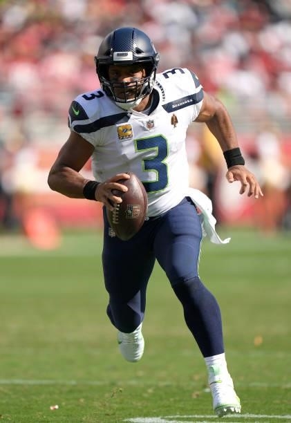 Russell Wilson of the Seattle Seahawks runs for a touchdown against the San Francisco 49ers during the third quarter at Levi's Stadium on October 03,...