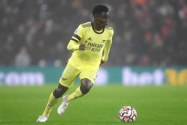 Bukayo Saka of Arsenal runs with the ball during the Premier League match between Brighton & Hove Albion and Arsenal at American Express Community...
