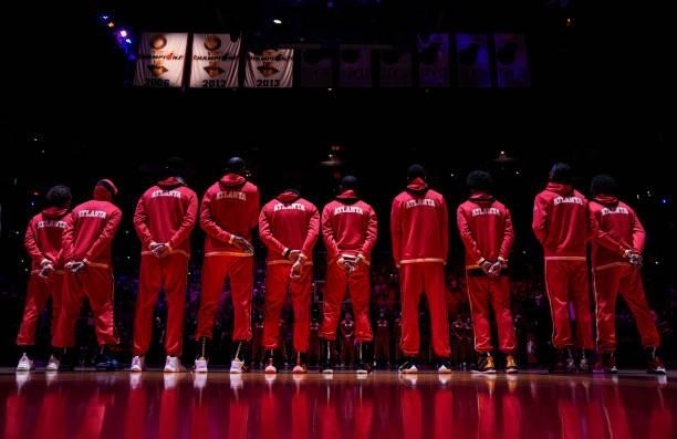The Atlanta Hawks line up for the national anthem prior to the preseason game against the Miami Heat at FTX Arena on October 04, 2021 in Miami,...