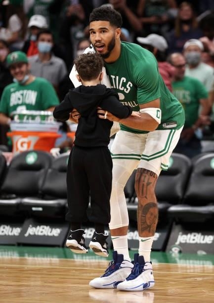 Jayson Tatum of the Boston Celtics holds his son Deuce following the preseason game against the Orlando Magic at TD Garden on October 04, 2021 in...