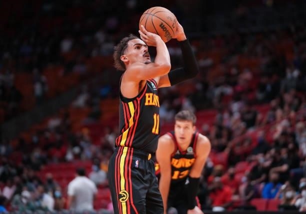 Trae Young of the Atlanta Hawks shoots a free throw in the second quarter against the Miami Heat in preseason action at FTX Arena on October 04, 2021...