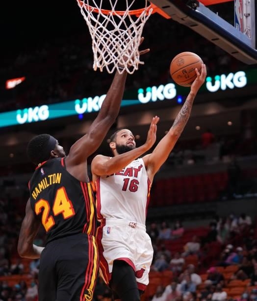 Caleb Martin of the Miami Heat drives to the basket against Johnny Hamilton of the Atlanta Hawks in the fourth quarter of preseason action at FTX...