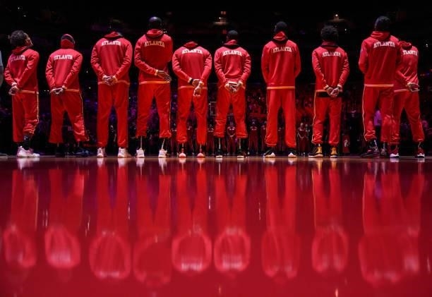 The Atlanta Hawks line up for the national anthem prior to preseason action against the Miami Heat at FTX Arena on October 04, 2021 in Miami,...