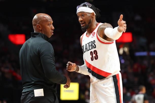 Head Coach Chauncey Billups of the Portland Trail Blazers and Robert Covington have a conversation against the Golden State Warriors in the third...