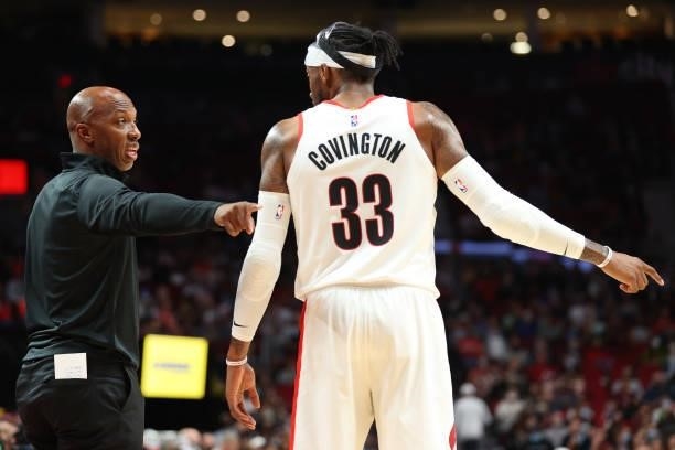 Head Coach Chauncey Billups of the Portland Trail Blazers and Robert Covington have a conversation against the Golden State Warriors in the third...