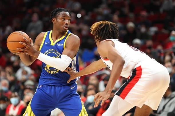 Jonathan Kuminga of the Golden State Warriors handles the ball against Greg Brown III of the Portland Trail Blazers in the fourth quarter during the...