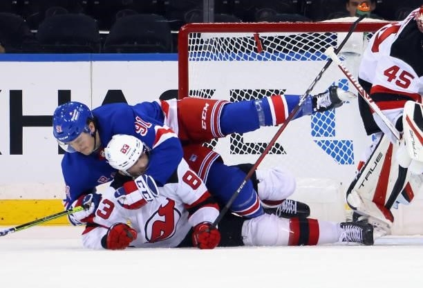 Sammy Blais of the New York Rangers wrestles with Christian Jaros of the New Jersey Devils during the first period during a preseason game at Madison...