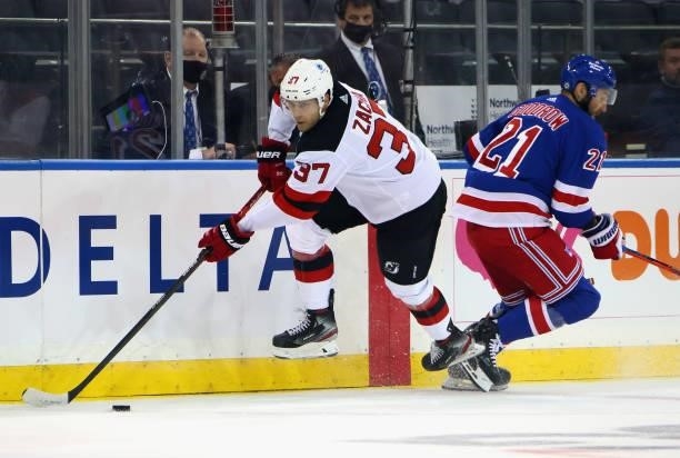 Pavel Zacha of the New Jersey Devils sidesteps a check from Barclay Goodrow of the New York Rangers during the first period during a preseason game...