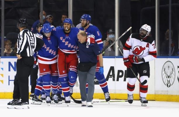 Ryan Reaves of the New York Rangers is injured on a check from P.K. Subban of the New Jersey Devils during the first period during a preseason game...