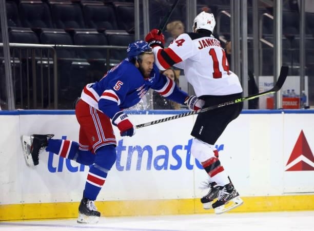 Jarred Tinordi of the New York Rangers checks Mark Jankowski of the New Jersey Devils during the first period during a preseason game at Madison...