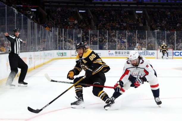 Michal Kempny of the Washington Capitals defends David Pastrnak of the Boston Bruins during the first period of the preseason game at TD Garden on...