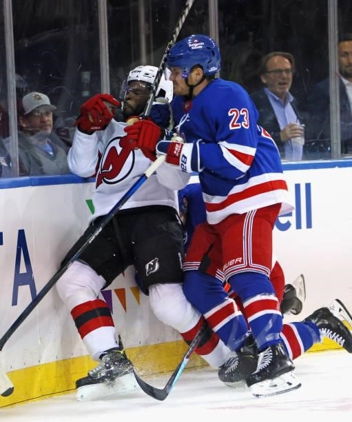 Ryan Strome and Adam Fox of the New York Rangers combine to hit P.K. Subban of the New Jersey Devils following an injury to teammate Ryan Reeves...