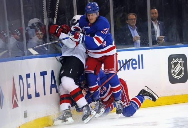 Ryan Strome and Adam Fox of the New York Rangers combine to hit P.K. Subban of the New Jersey Devils following an injury to teammate Ryan Reeves...