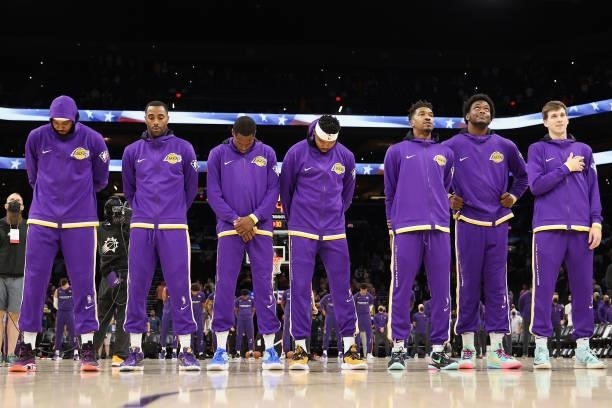 The Los Angeles Lakers stand attended for the national anthem before the NBA preseason game against the Phoenix Suns at Footprint Center on October...