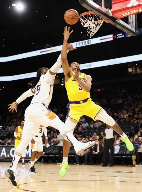 Talen Horton-Tucker of the Los Angeles Lakers attempts a shot under pressure from Jae Crowder of the Phoenix Suns during the first half of the NBA...