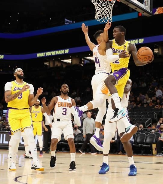 Kendrick Nunn of the Los Angeles Lakers makes a leaping pass pressured by Landry Shamet of the Phoenix Suns during the first half of the NBA...