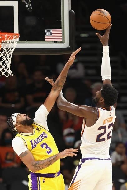 Deandre Ayton of the Phoenix Suns attempts a shot over Anthony Davis of the Los Angeles Lakers during the first half of the NBA preseason game at...
