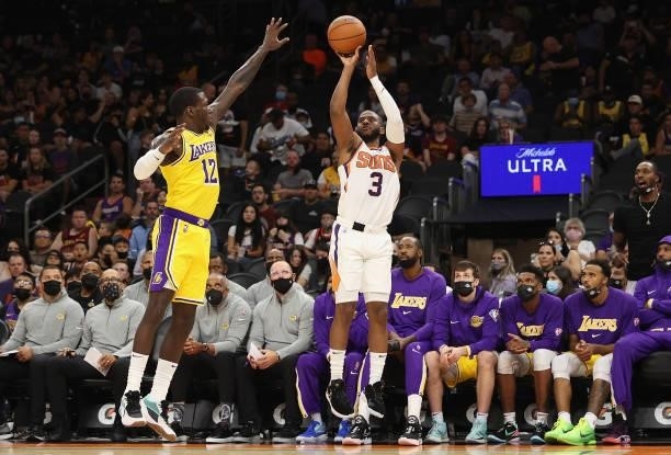 Chris Paul of the Phoenix Suns puts up a three-point shot over Kendrick Nunn of the Los Angeles Lakers during the NBA preseason game at Footprint...