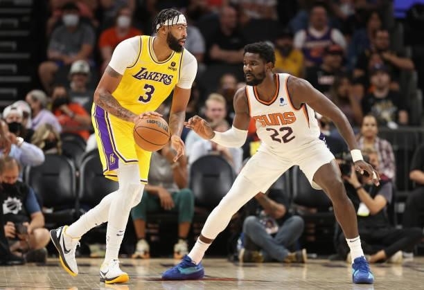 Anthony Davis of the Los Angeles Lakers handles the ball under pressure from Deandre Ayton of the Phoenix Suns during the second half of the NBA...