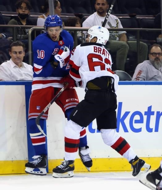 Artemi Panarin of the New York Rangers is checked by Jesper Bratt of the New Jersey Devils during the second period during a preseason game at...