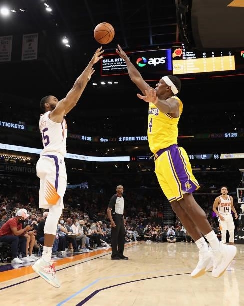 Mikal Bridges of the Phoenix Suns attempts a three-point shot over Rajon Rondo of the Los Angeles Lakers during the second half of the NBA preseason...