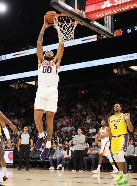 JaVale McGee of the Phoenix Suns slam dunks the ball over Talen Horton-Tucker of the Los Angeles Lakers during the second half of the NBA preseason...