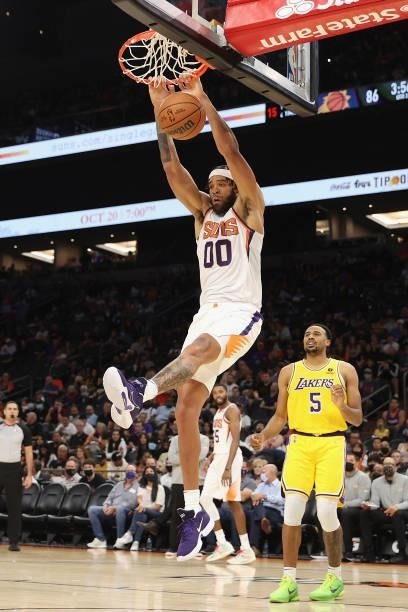 JaVale McGee of the Phoenix Suns slam dunks the ball over Talen Horton-Tucker of the Los Angeles Lakers during the second half of the NBA preseason...