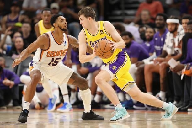 Austin Reaves of the Los Angeles Lakers drives the ball against Cameron Payne of the Phoenix Suns during the second half of the NBA preseason game at...