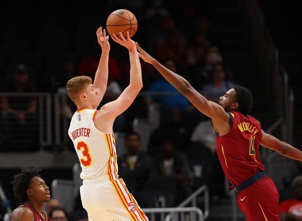Kevin Huerter of the Atlanta Hawks attempts a shot against Evan Mobley of the Cleveland Cavaliers during the first half at State Farm Arena on...