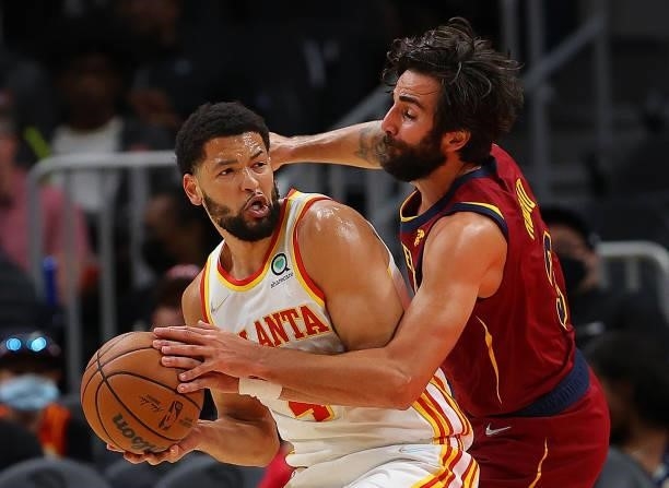 Ricky Rubio of the Cleveland Cavaliers defends Skylar Mays of the Atlanta Hawks during the first half at State Farm Arena on October 06, 2021 in...