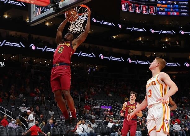 Collin Sexton of the Cleveland Cavaliers dunks against Kevin Huerter of the Atlanta Hawks during the first half at State Farm Arena on October 06,...