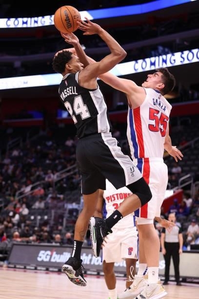 Devin Vassell of the San Antonio Spurs tries to get a shot of over Luka Garza of the Detroit Pistons during a preseason game at Little Caesars Arena...