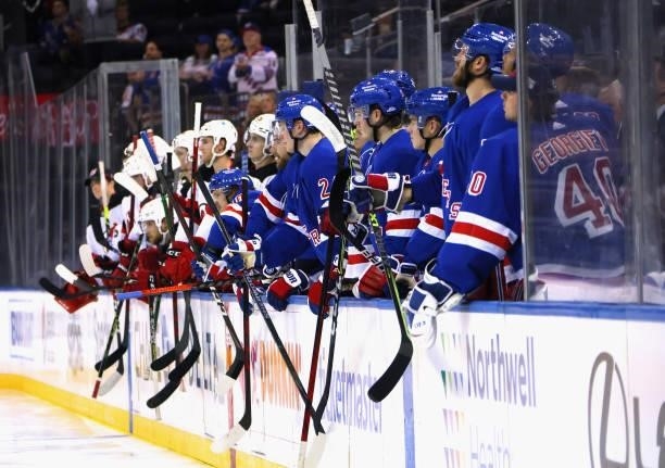 The New York Rangers and the New Jersey Devils salute players following a third period fight during a preseason game at Madison Square Garden on...