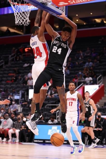 Devin Vassell of the San Antonio Spurs looses the ball next to Jamorko Pickett of the Detroit Pistons during a preseason game at Little Caesars Arena...