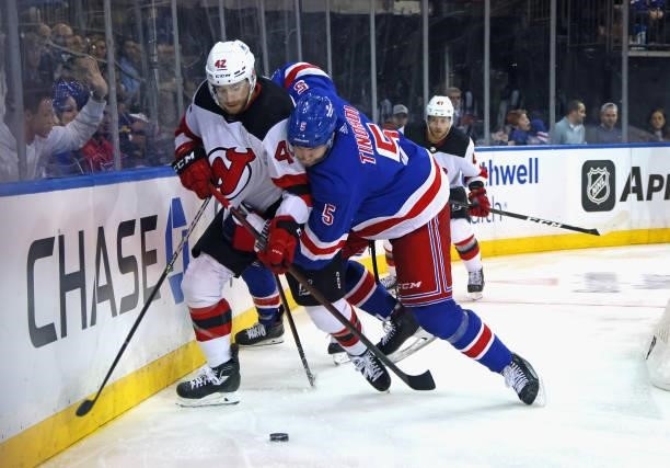Jarred Tinordi of the New York Rangers holds onto A.J. Greer of the New Jersey Devils during the third period during a preseason game at Madison...