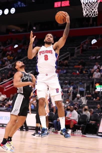 Trey Lyles of the Detroit Pistons grabs a rebound in front Bryn Forbes of the San Antonio Spurs during a preseason game at Little Caesars Arena on...