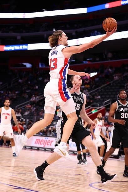 Kelly Olynyk of the Detroit Pistons drives to the basket past Jakob Poeltl of the San Antonio Spurs during a preseason game at Little Caesars Arena...