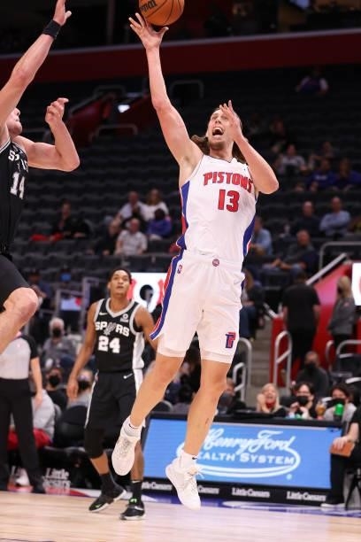 Kelly Olynyk of the Detroit Pistons drives to the basket against Drew Eubanks of the San Antonio Spurs during a preseason game at Little Caesars...